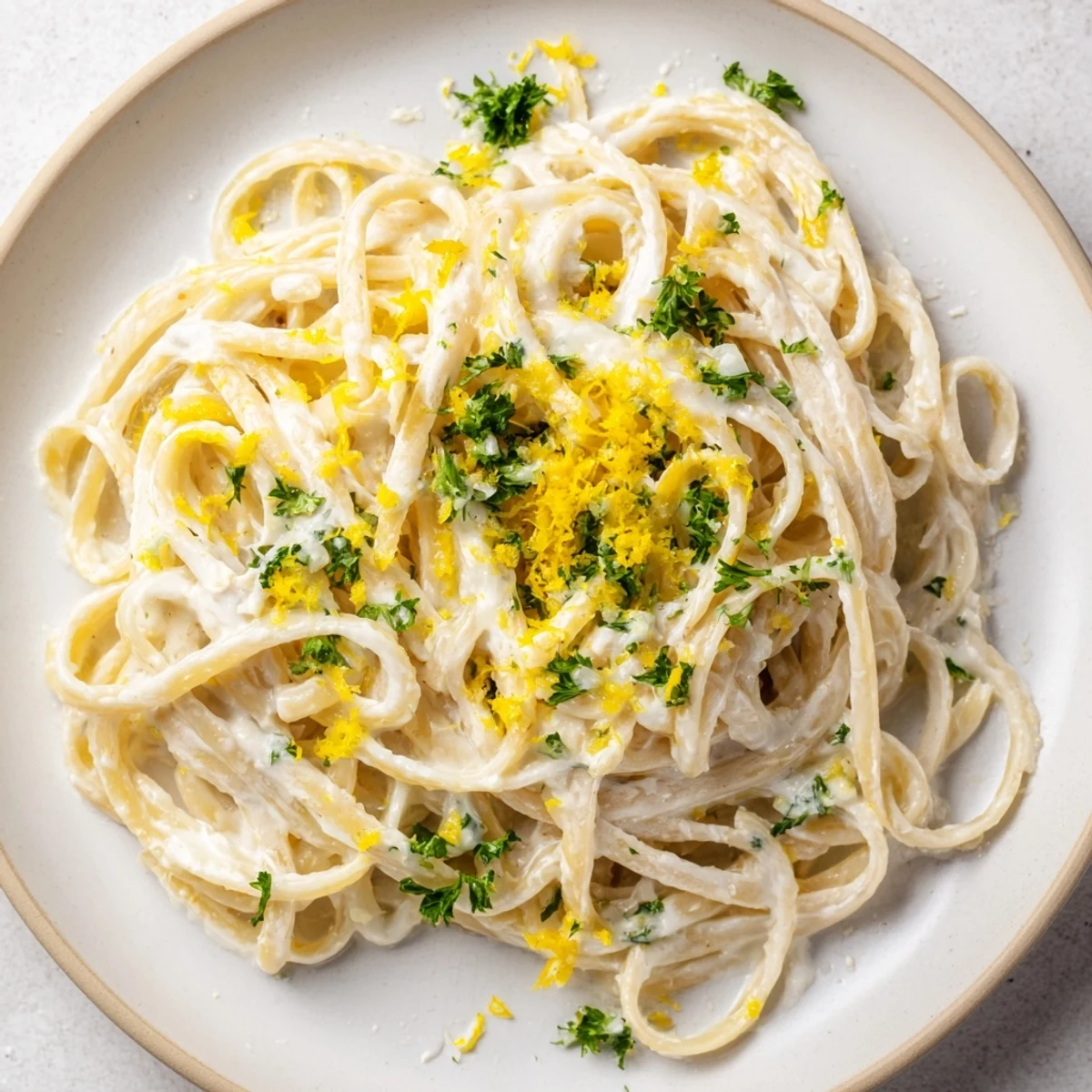 The flavorful Lemon-Garlic Greek Yogurt Pasta, garnished with parsley and lemon slices.