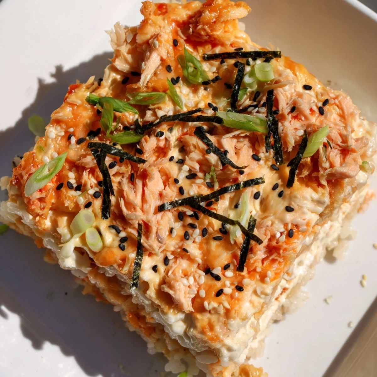 Mouthwatering close-up of Creamy Salmon Sushi Bake, ready to serve with crispy nori sheets.