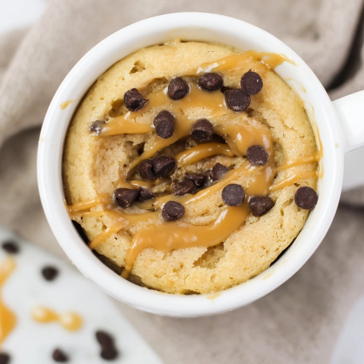 A warm, single-serve 2-Minute Peanut Butter Mug Cake, rich in peanut butter flavor and ready quickly.