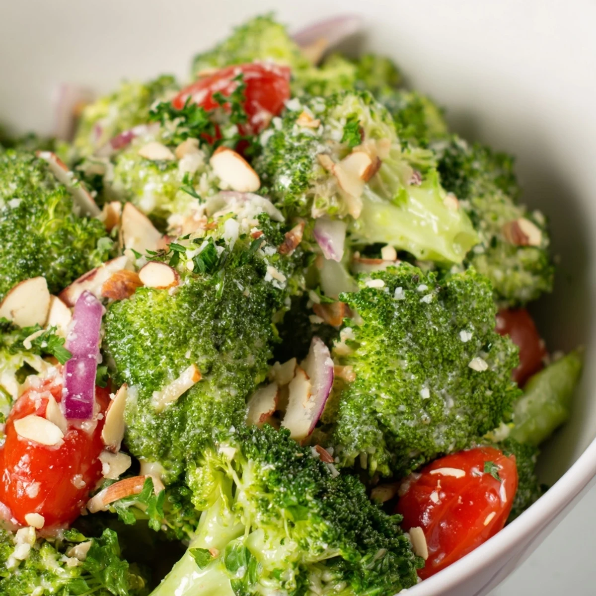 Vibrant green broccoli florets tossed in creamy garlic Parmesan dressing, topped with toasted almonds for a refreshing salad.  