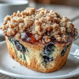 1. Lemon blueberry sourdough crumb muffins with golden tops and juicy berry bursts, perfect for breakfast or a sweet snack.  