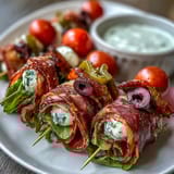 Italian Sub Skewers with Aioli: Bite-sized layers of salami, ham, mozzarella, and fresh vegetables, drizzled with zesty homemade