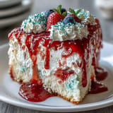 Colorful Memorial Day Red White Blue Poke Cake, bursting with berry fruit flavors.