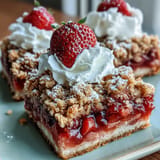 Enjoy these sweet and tangy strawberry rhubarb crumble bars, perfect for dessert.