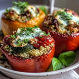 Vibrant bell peppers overflowing with hearty quinoa and roasted vegetables.