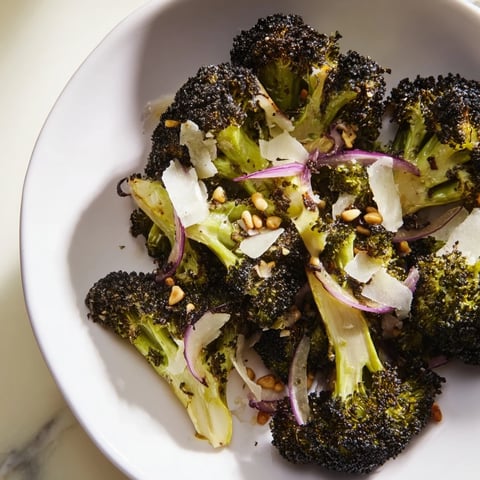 Beautiful charred broccoli salad with smoky edges, lemon dressing, and Parmesan cheese.