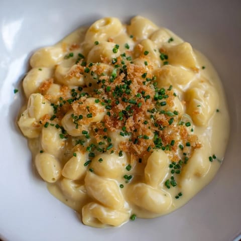 A close-up of cheesy, stovetop mac and cheese, perfectly coating each pasta curve.