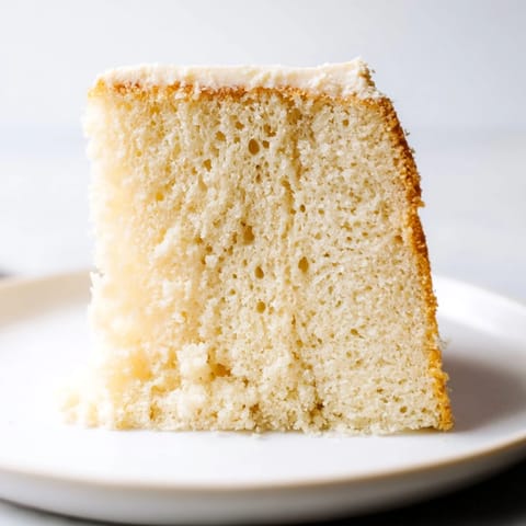 Fluffy 3-ingredient vanilla sponge cake, golden brown from the oven, ready to enjoy.