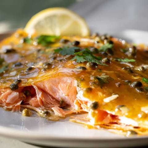 Golden brown honey mustard glazed salmon topped with parsley, plated for a delicious, easy meal.