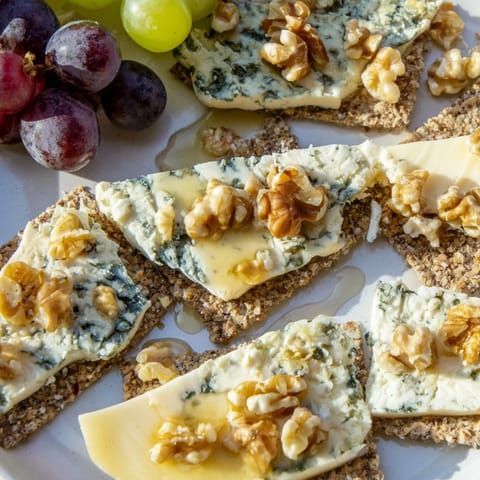Artfully arranged blue cheeses become a delightful “Blue Ridge Mountains” cheese platter with honey and grapes.