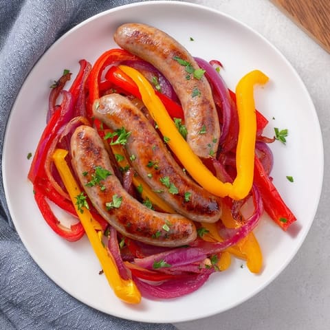 Golden-brown Italian sausage, mixed with colorful peppers and onions, ready for easy sheet pan dinner.