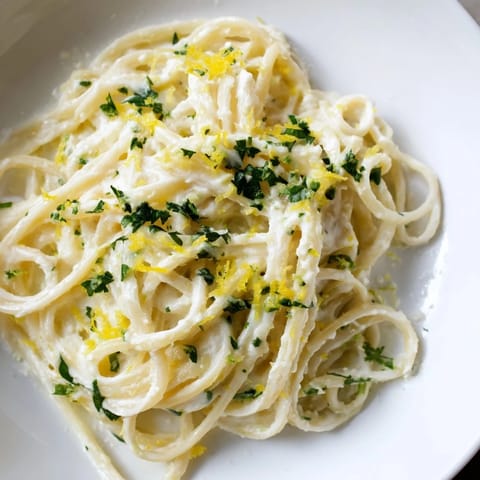 A delicious bowl of Lemon-Garlic Greek Yogurt Pasta, ready to be enjoyed with parmesan.