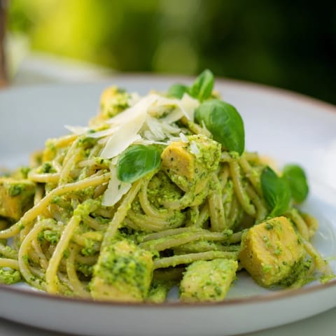 Spoonful of golden pesto egg sauce coating the spaghetti in this Pesto Egg and Chicken Pasta.