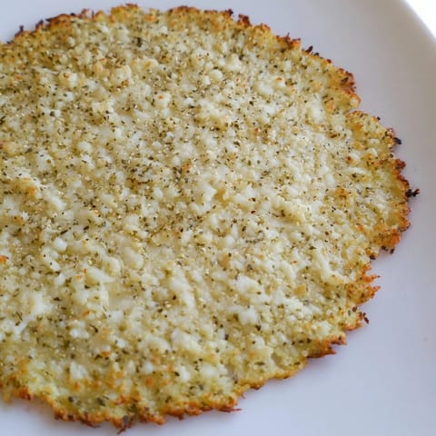 Perfectly baked, crisp Cauliflower Pizza Crust, a gluten-free base ready for your favorite pizza toppings.