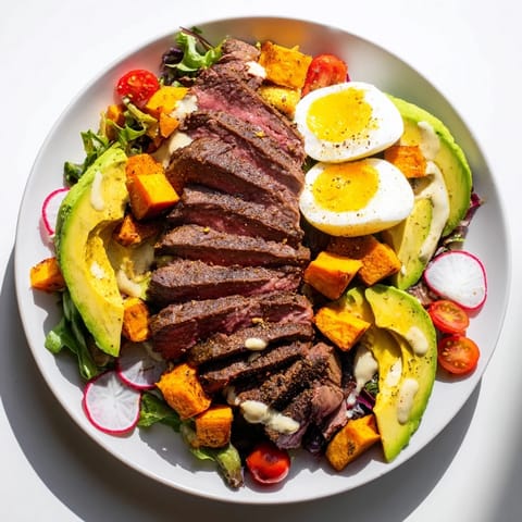 A delicious view of a fresh High-Protein Beef Avocado Bowl filled with colorful fresh ingredients.