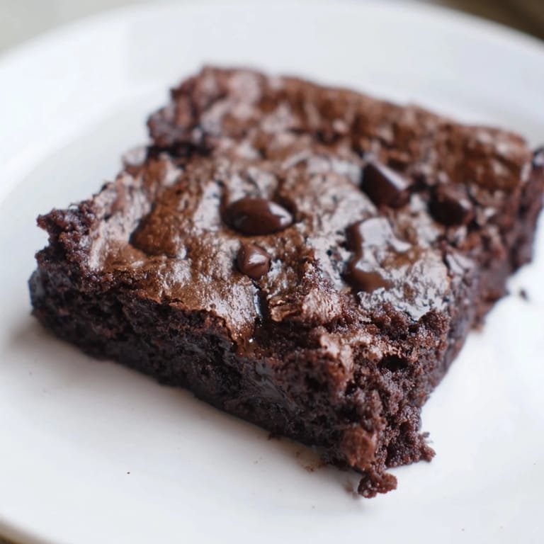 A square of decadent Greek yogurt brownies, presenting a delightful, guilt-free chocolate treat, ready to eat.