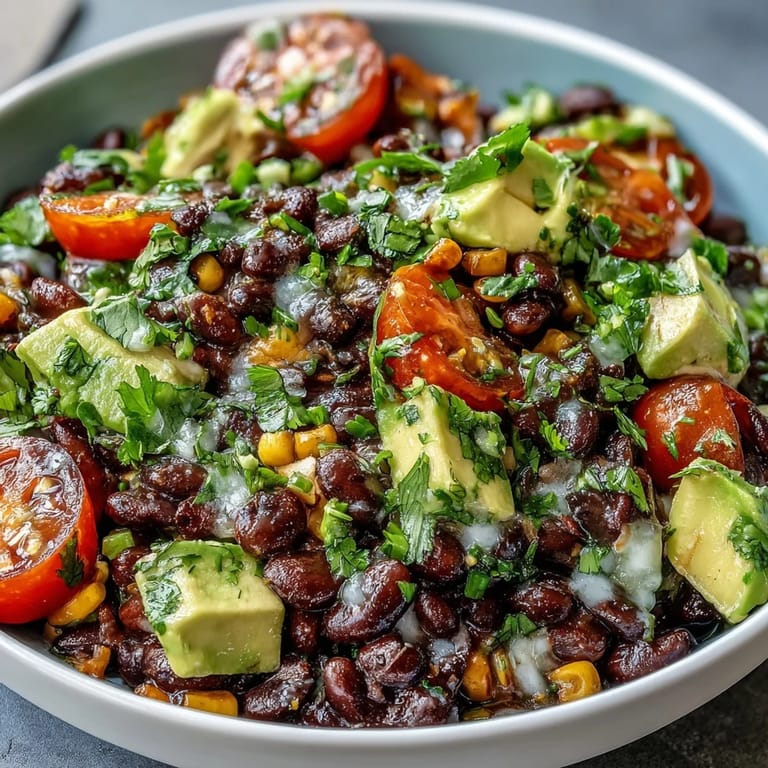Vibrant Black Bean and Veggie Bowl with creamy avocado, red onion, and pumpkin seeds on a rustic table.
