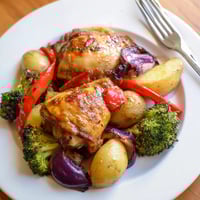 Honey Lemon Roasted Chicken Sheet Pan with golden skin, tender veggies, and zesty citrus glaze.