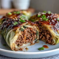 Steamed Korean Cabbage Rolls filled with savory beef, ready for dipping.